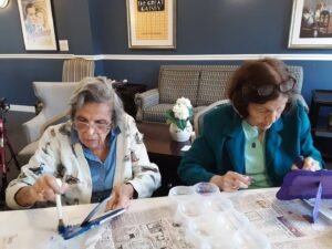 Senior residents painting picture frames